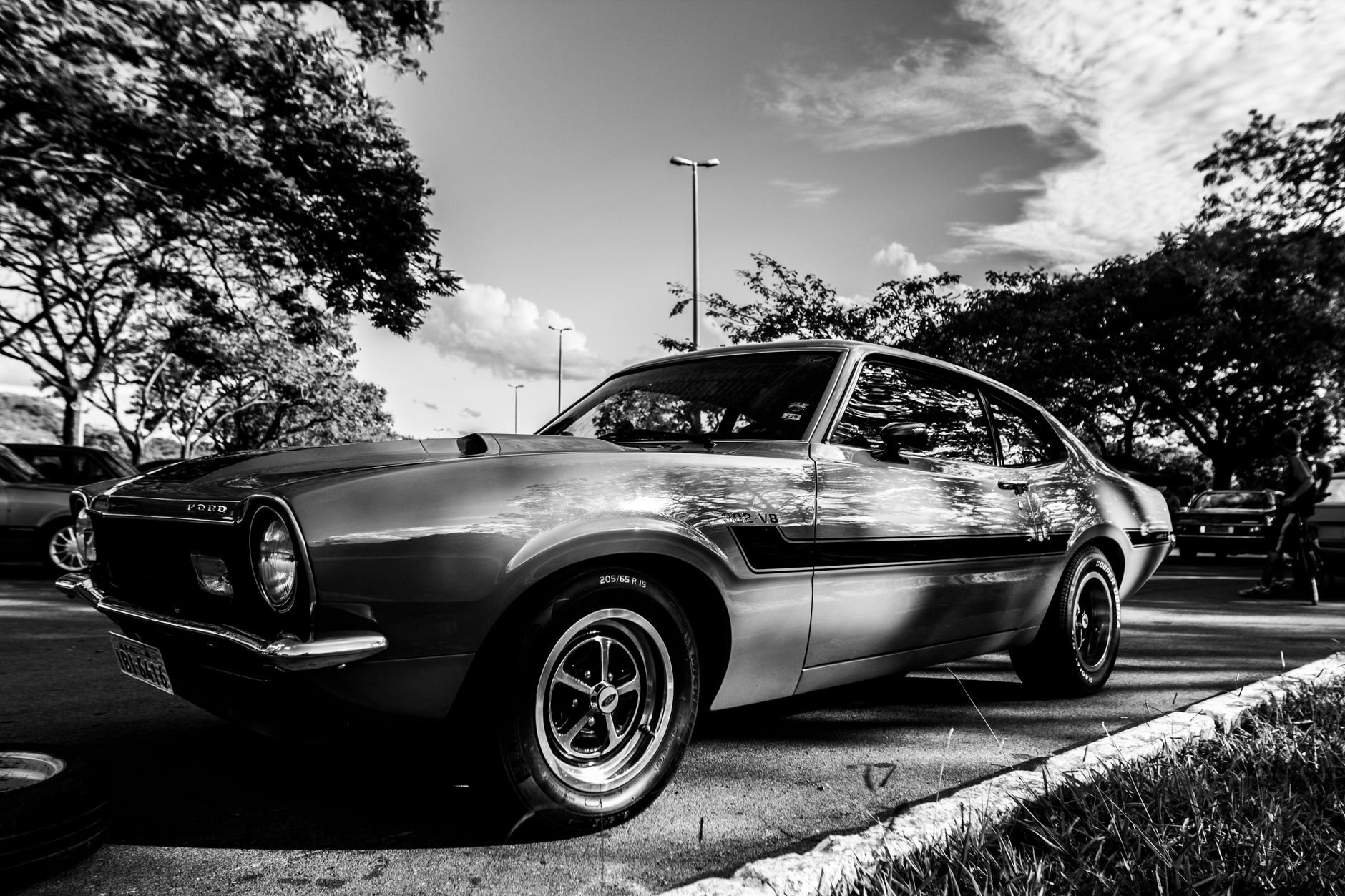 A retro vintage car in a classic black and white photograph taken outdoors.