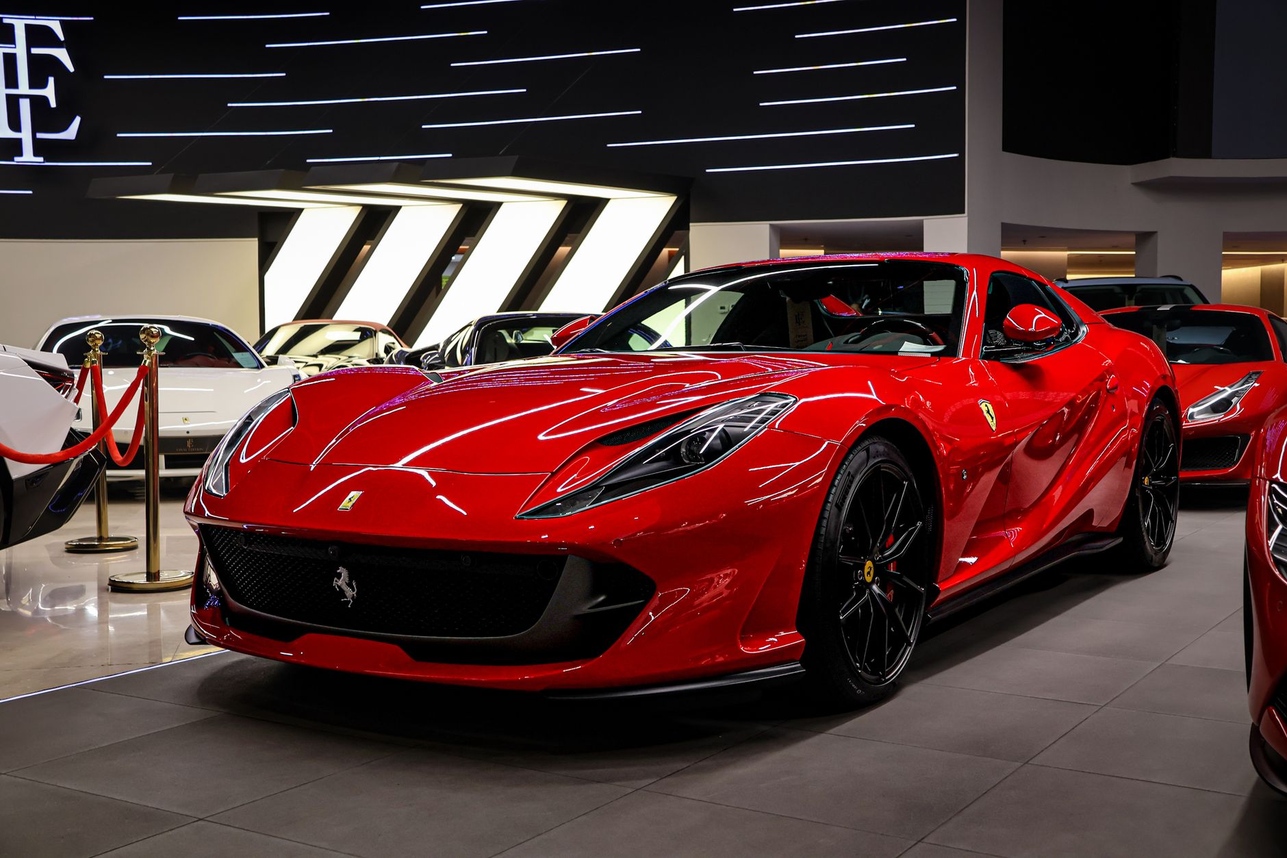 Eye-catching red sports car displayed in a contemporary auto showroom.