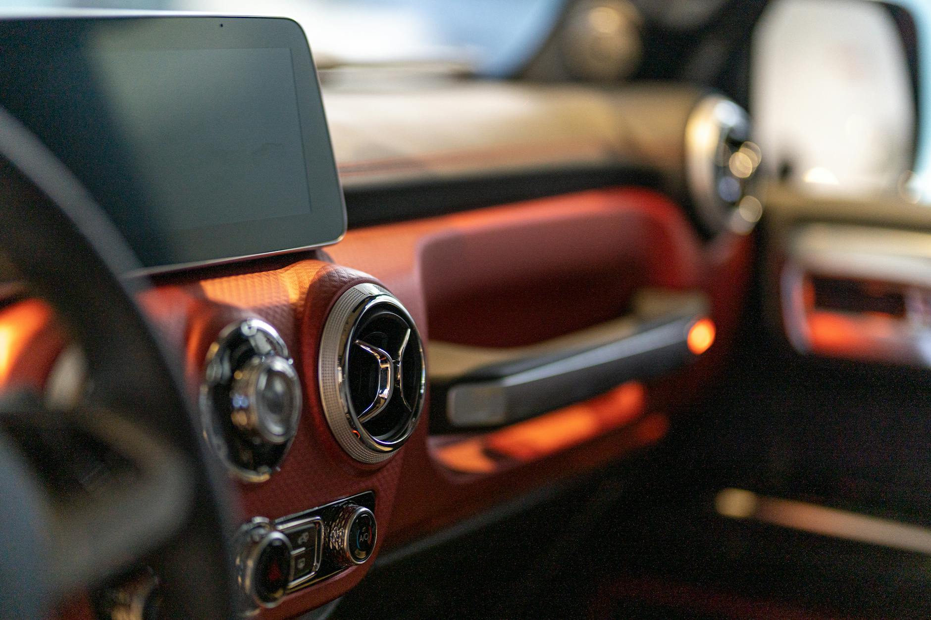 Close-up of a modern car's interior focusing on the digital dashboard and air vents.
