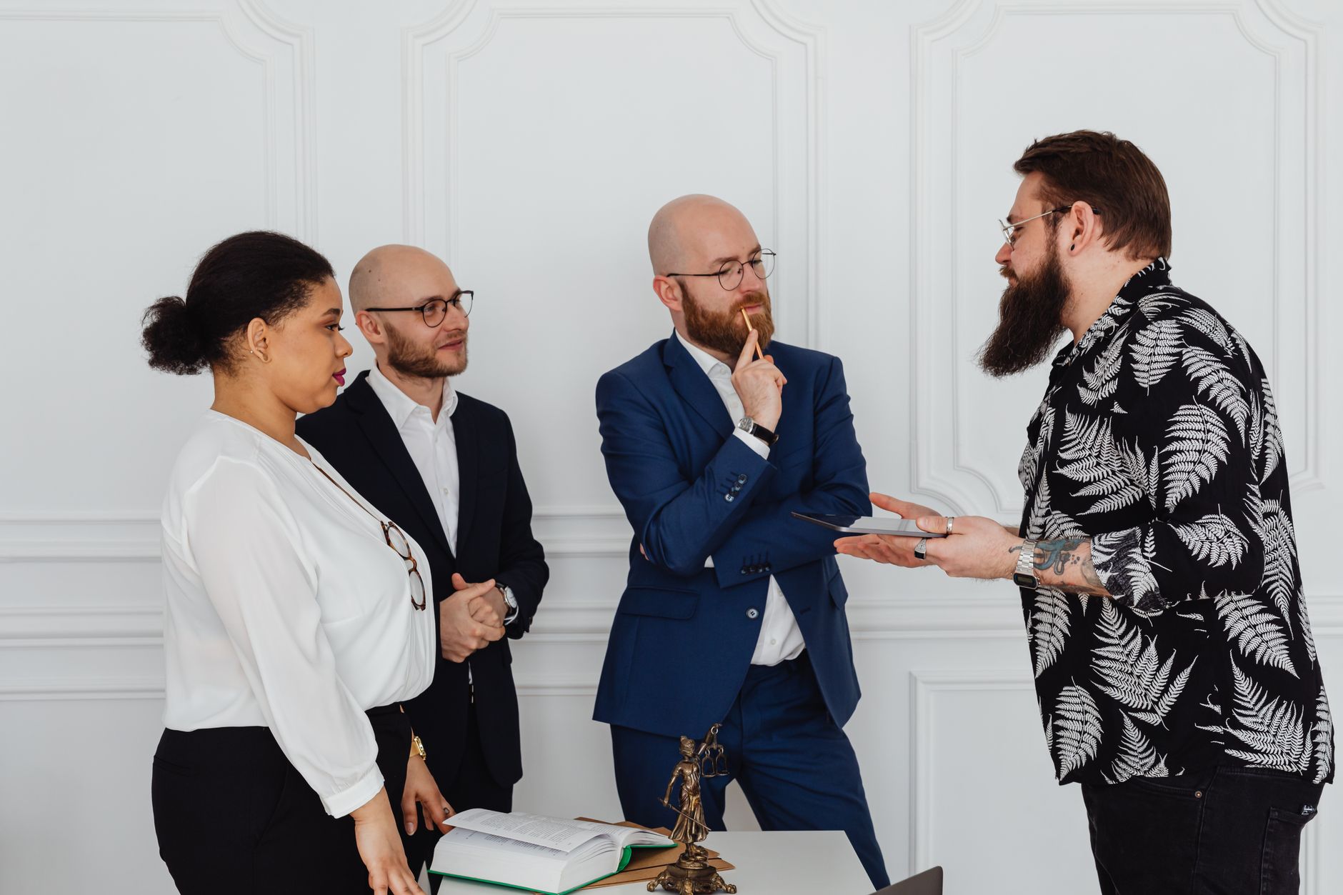 Group of professionals in office discussing documents and ideas during meeting.