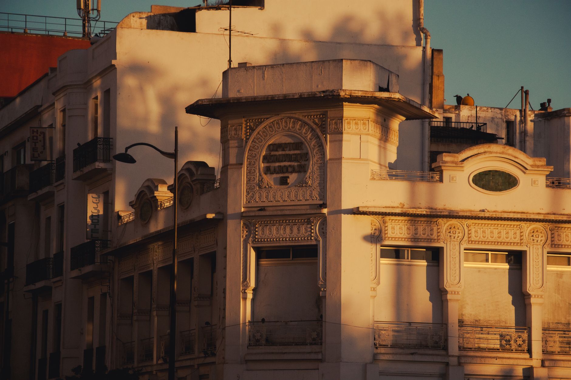 Sunset casts warm tones on ornate Moroccan architecture in Casablanca.