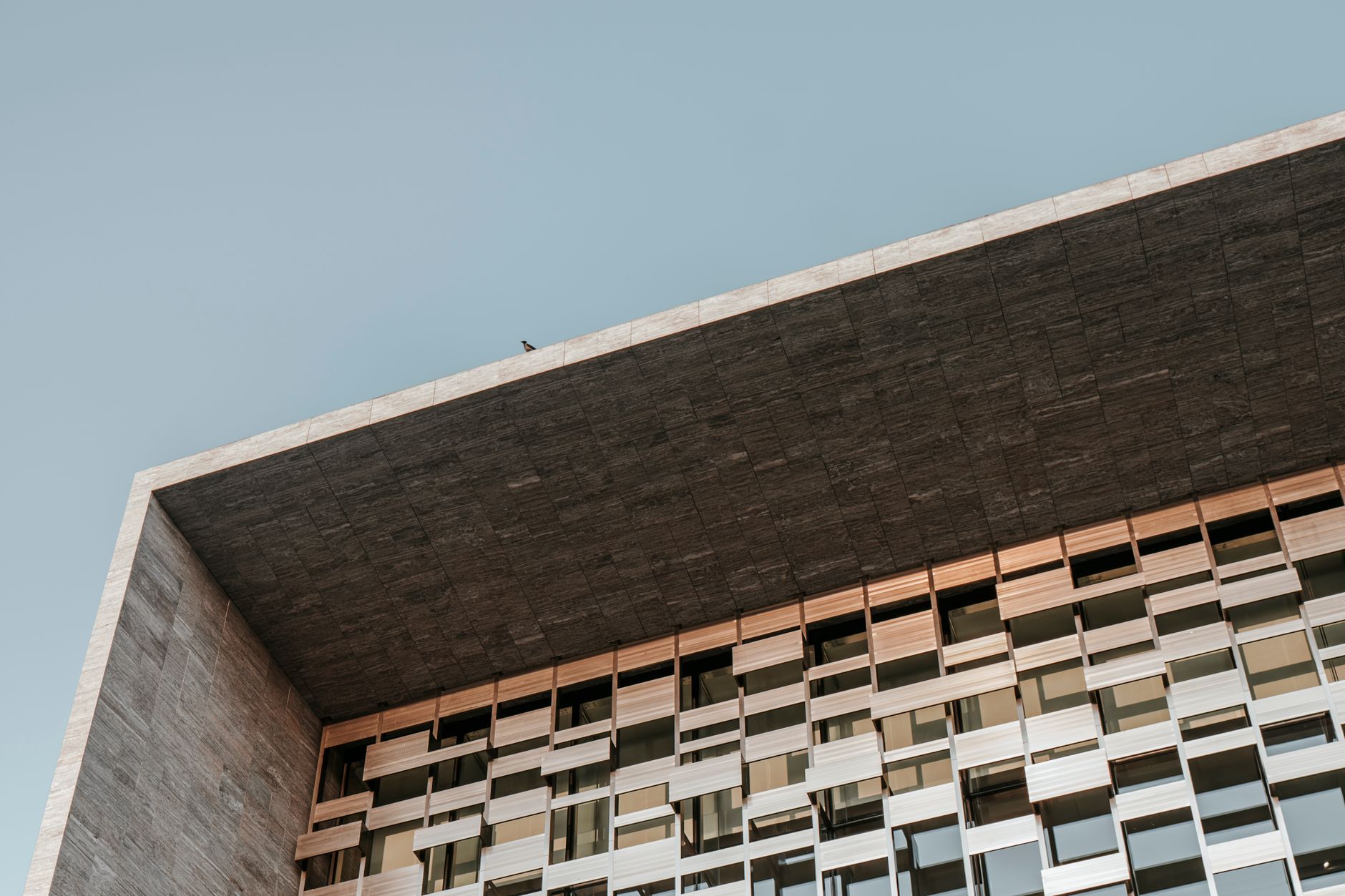 Contemporary building with geometric design featuring windows and minimalist architecture.