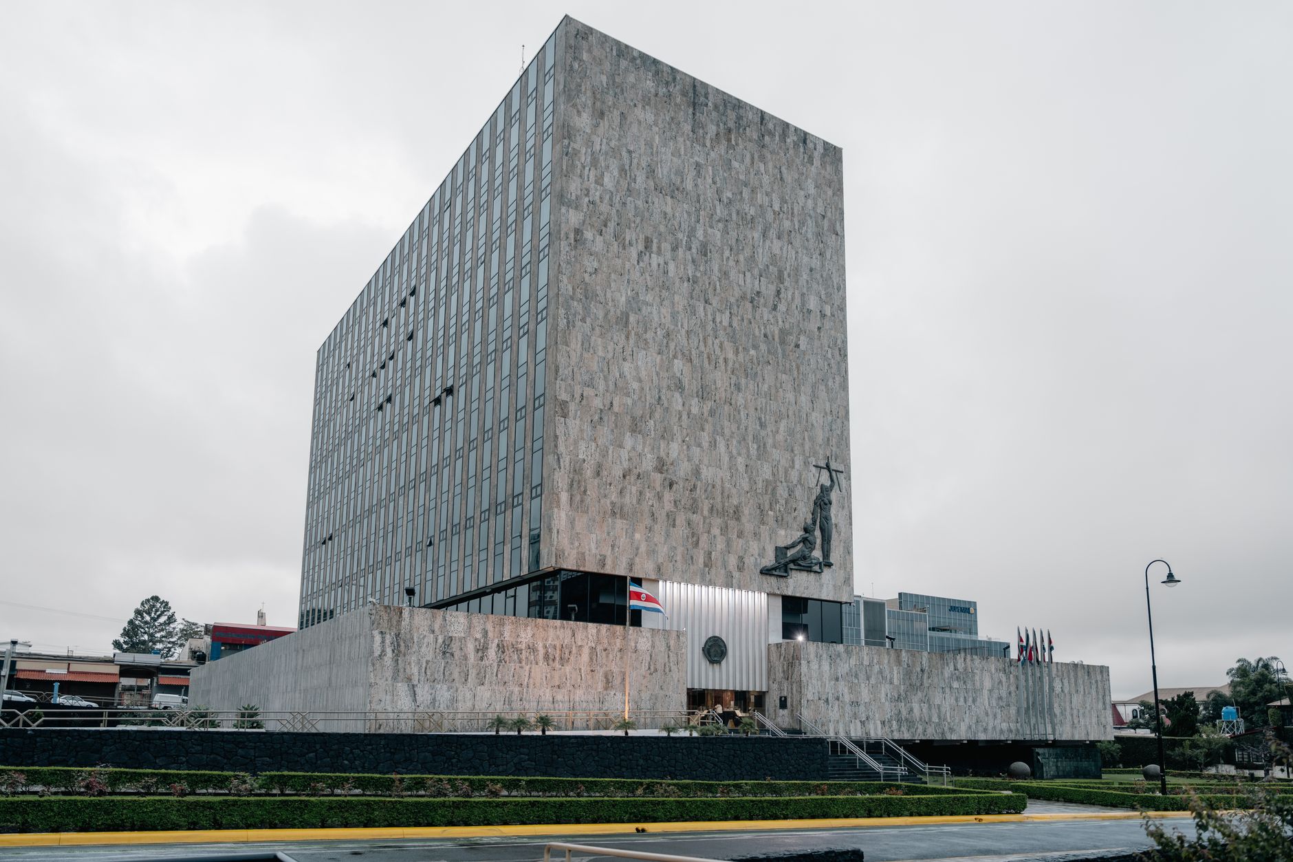 Architectural photo of the Supreme Court building in San José, Costa Rica featuring modern design and national flags.