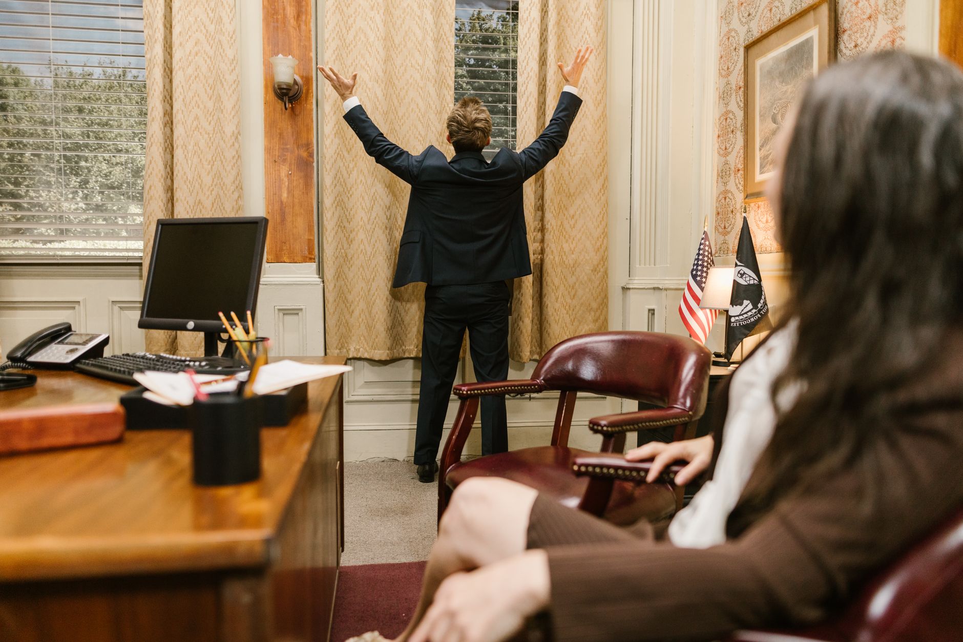 Two professionals in a lawyer's office engaged in a tense negotiation.