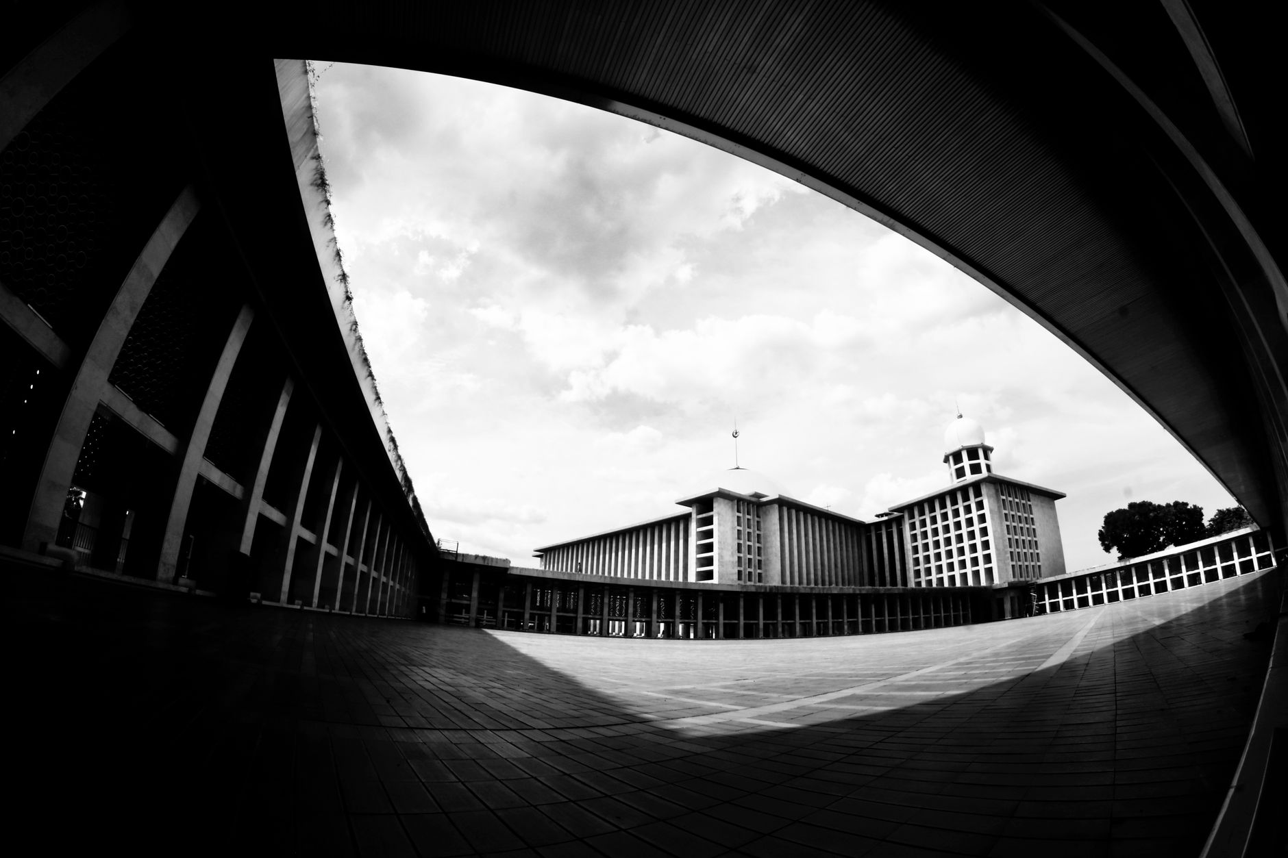 A striking black and white image of modern urban architecture with a wide angle perspective.
