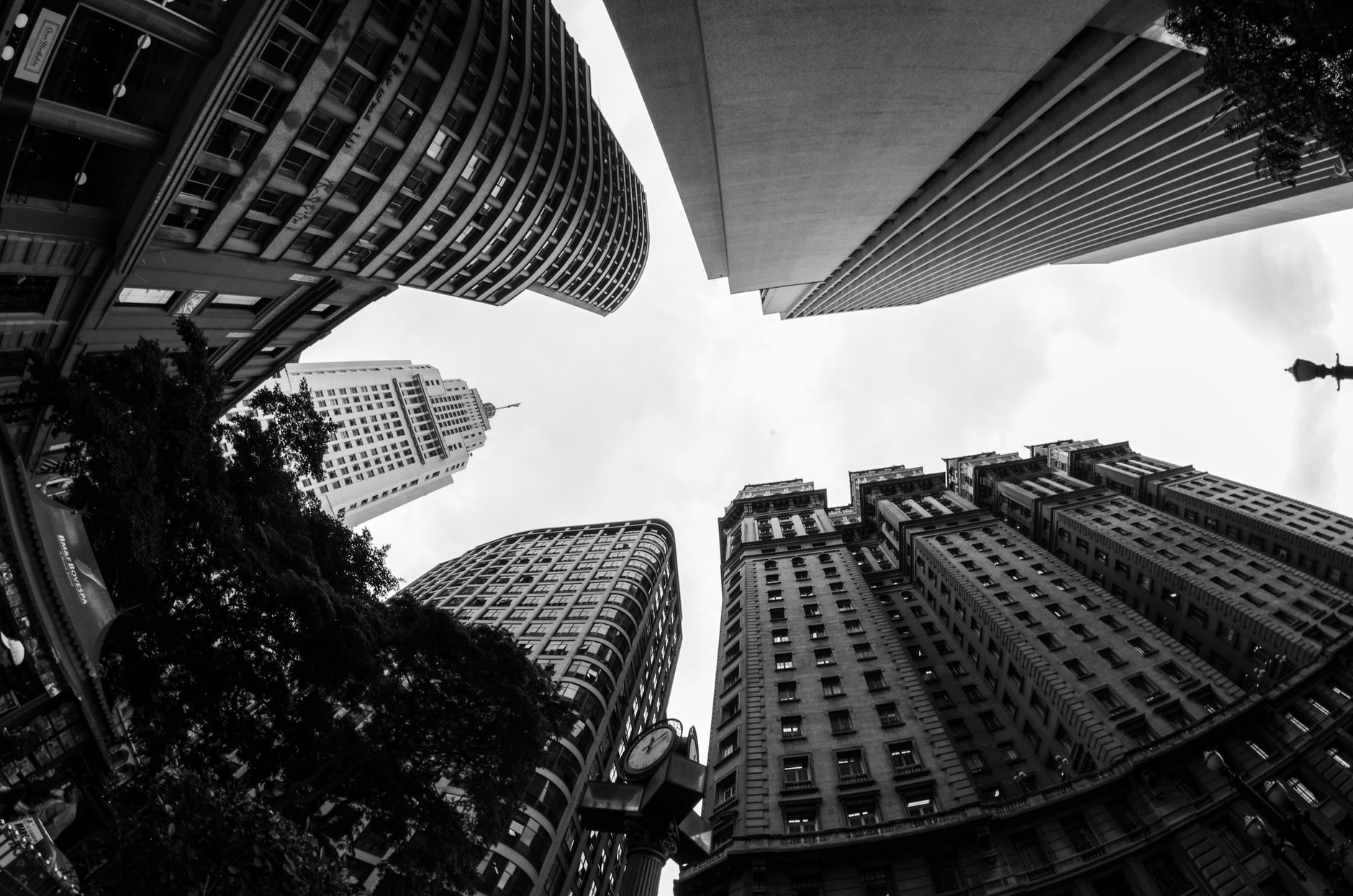 A striking black and white photo of towering skyscrapers viewed from below in an urban cityscape.