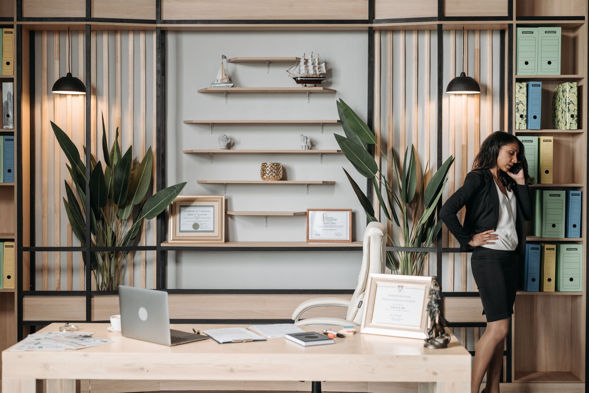 Businesswoman on phone in stylish office, showcasing professionalism and modern work environment.