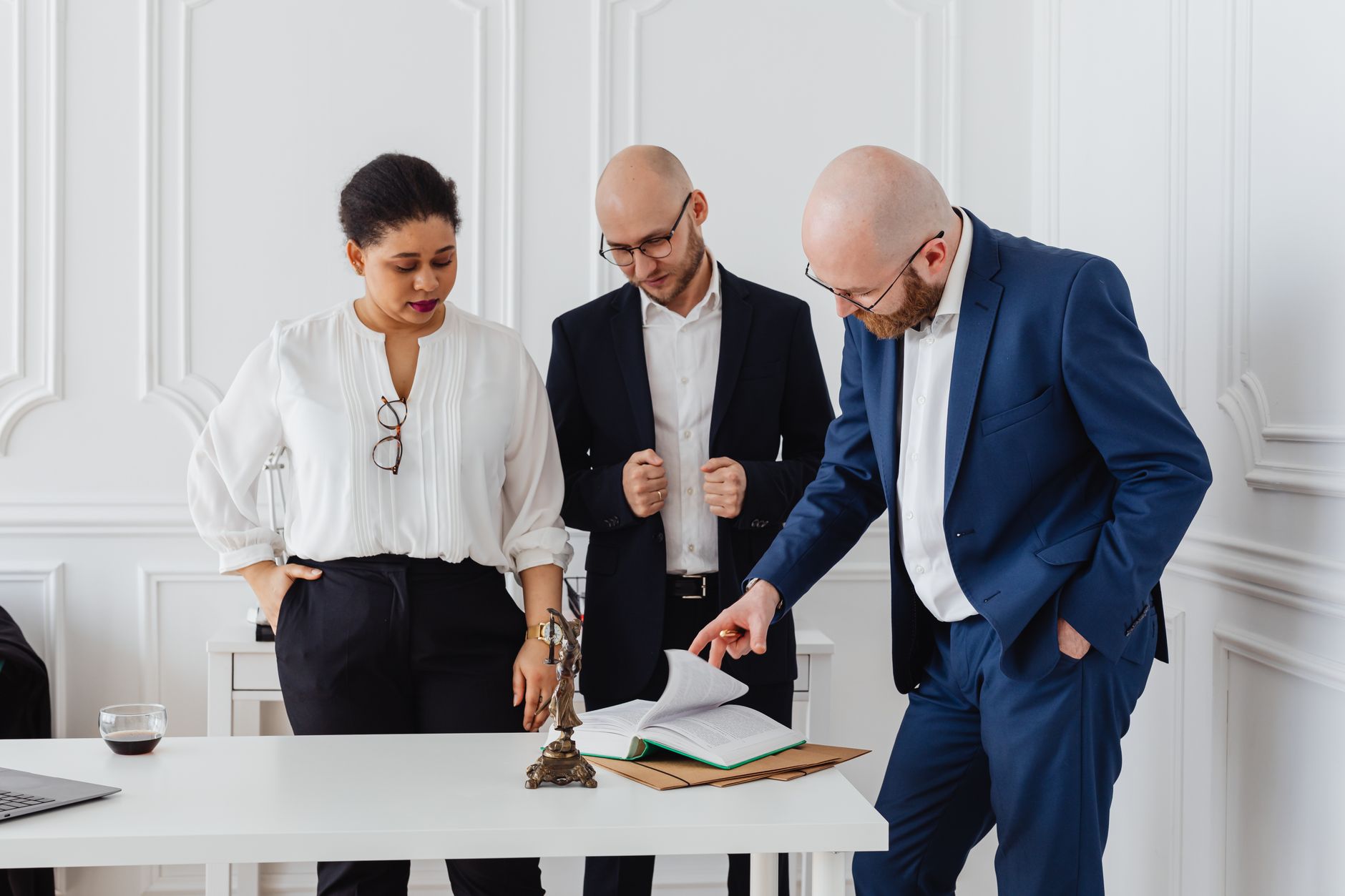 A diverse team of professionals analyzing documents in a modern office setting.