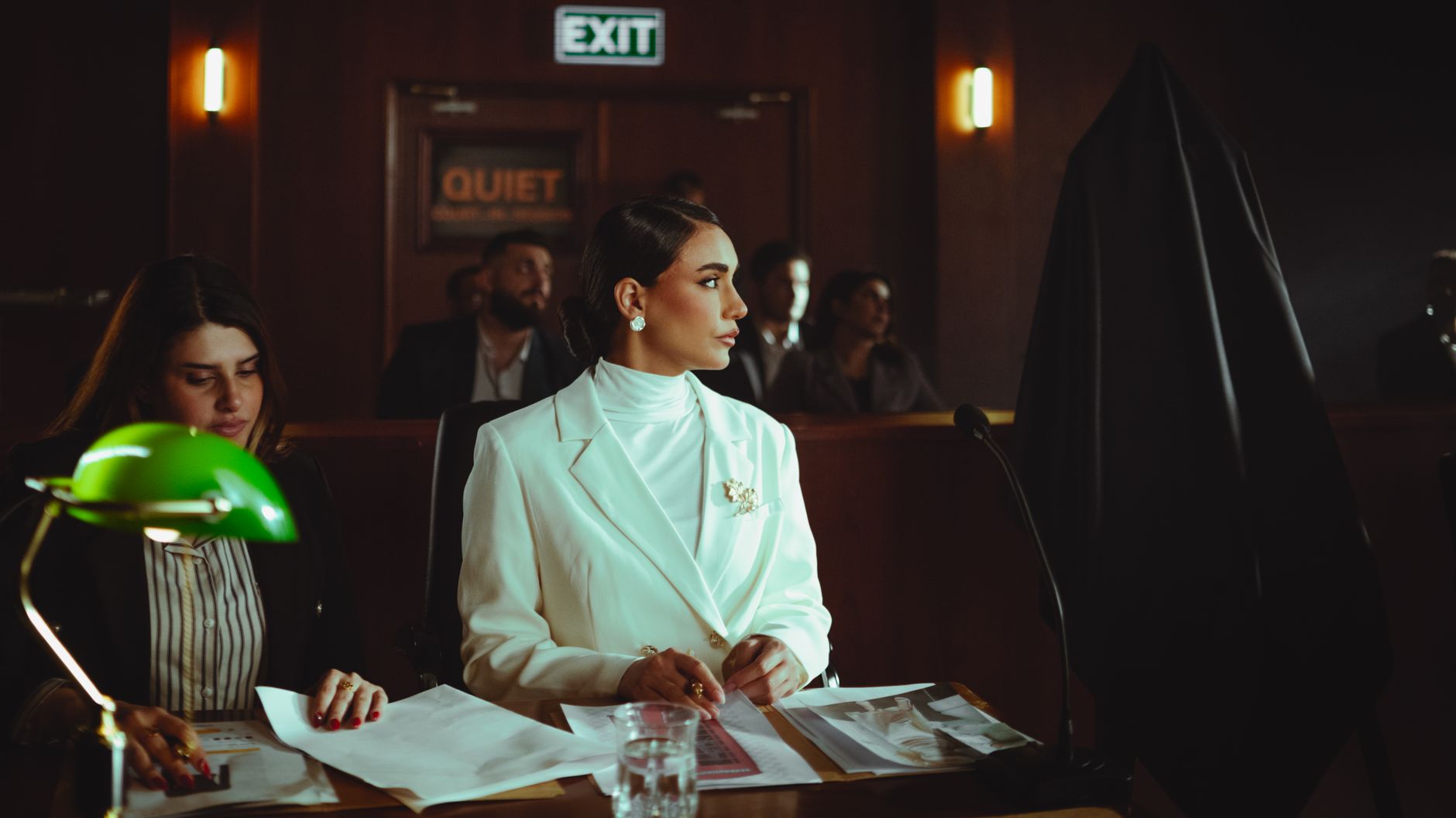 A businesswoman attentively listening in a courtroom environment, Baghdad, Iraq.