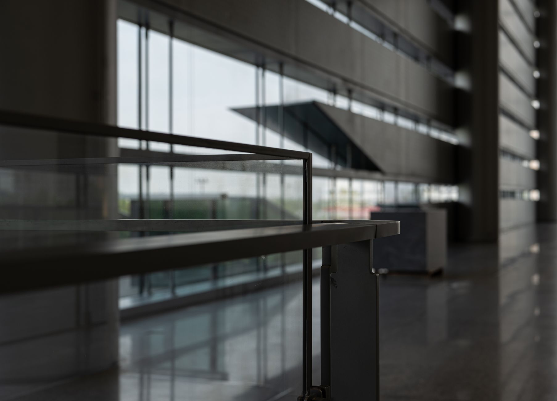 Sleek modern hallway in Shanghai featuring expansive glass windows and contemporary architecture.