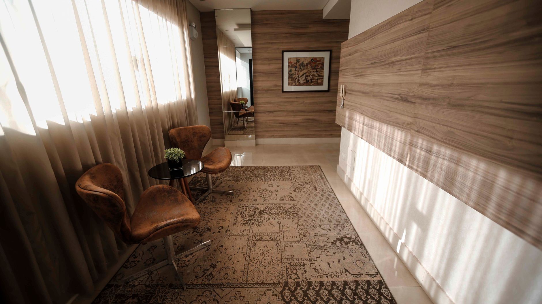 A stylish and serene seating area with elegant chairs, table, and decor in a well-lit room.