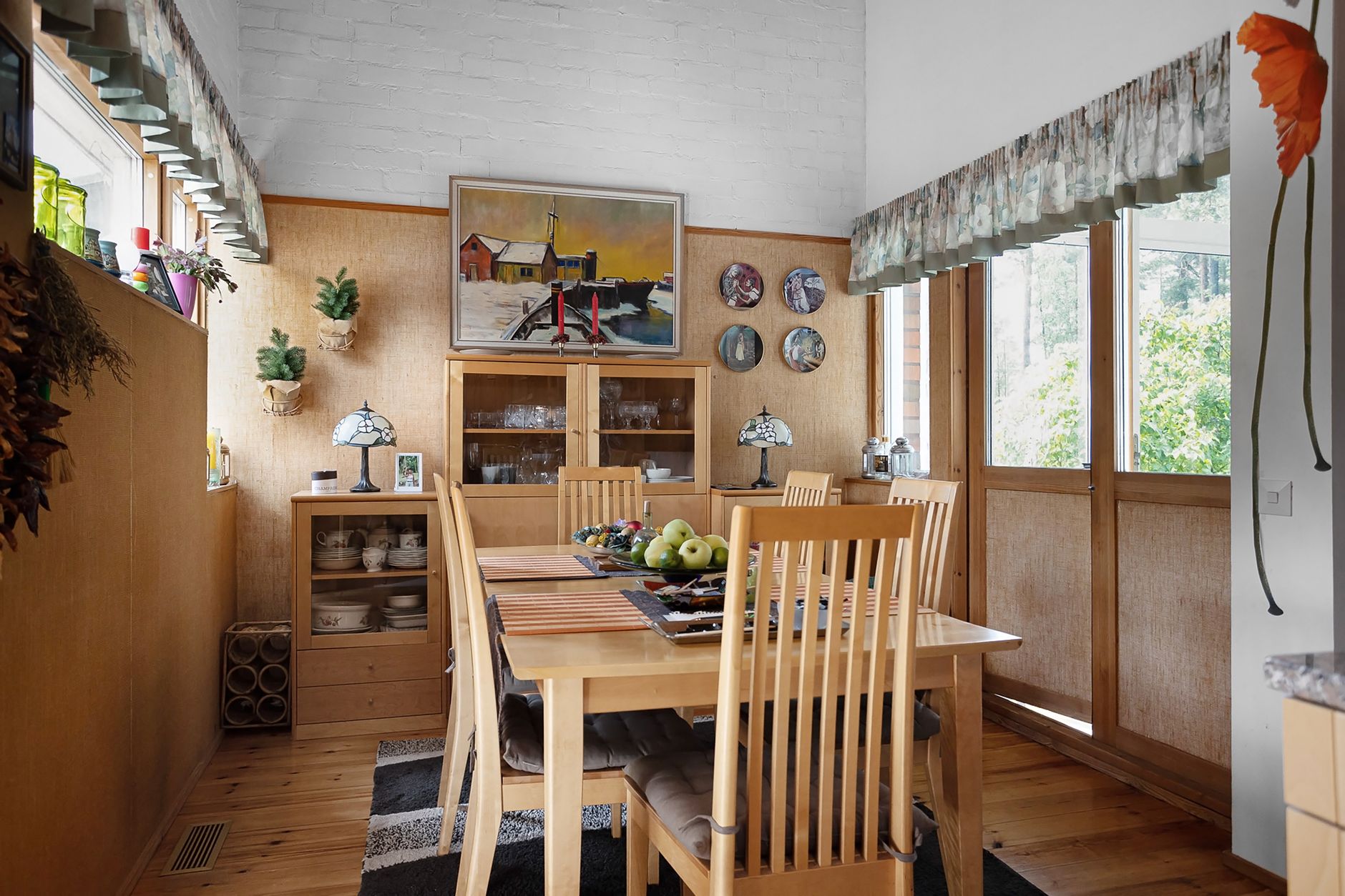 Rustic dining room with wooden furniture, decorative elements, and natural light.