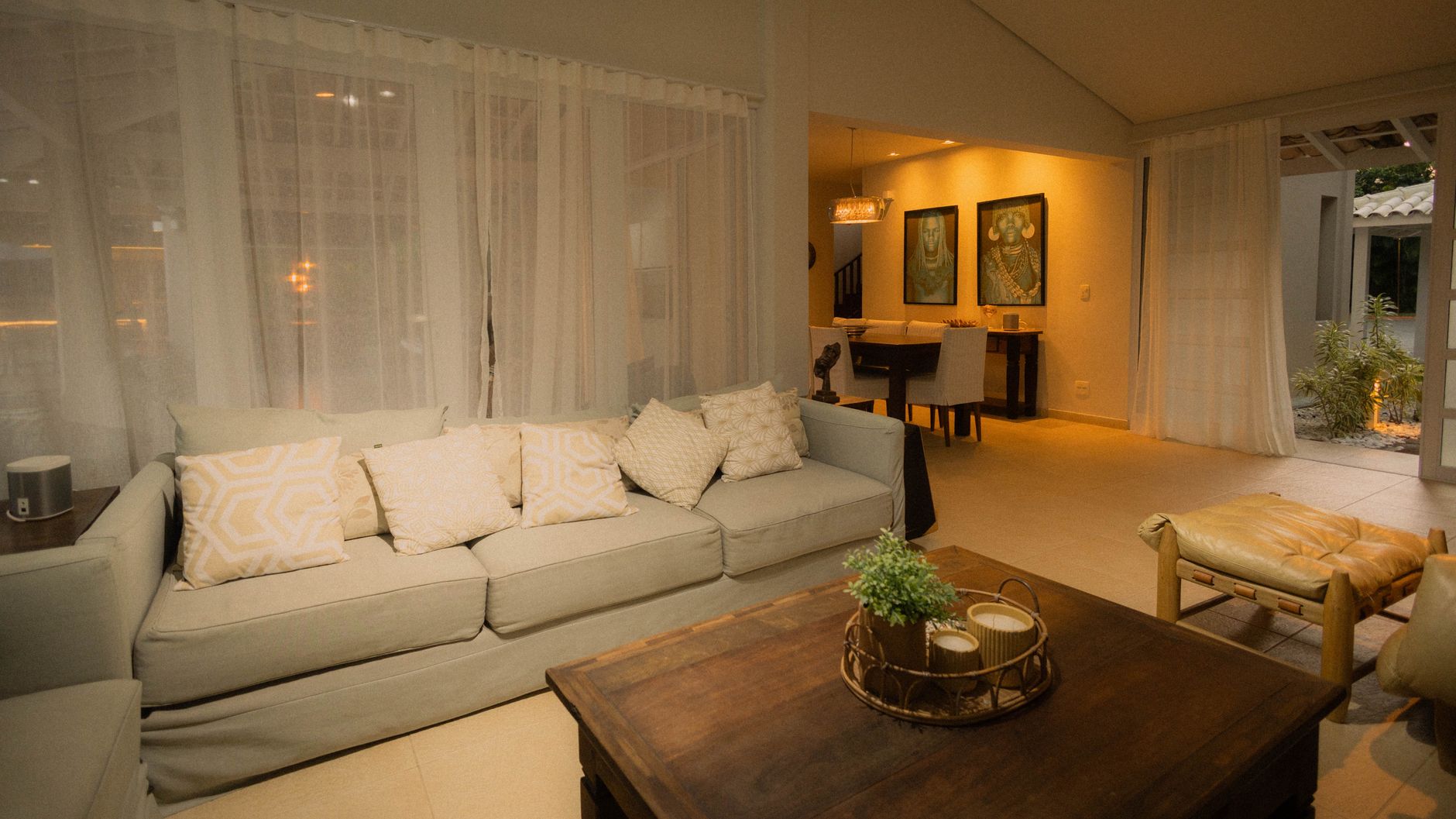 Inviting modern living room with neutral colors, elegant furniture, and ambient lighting.