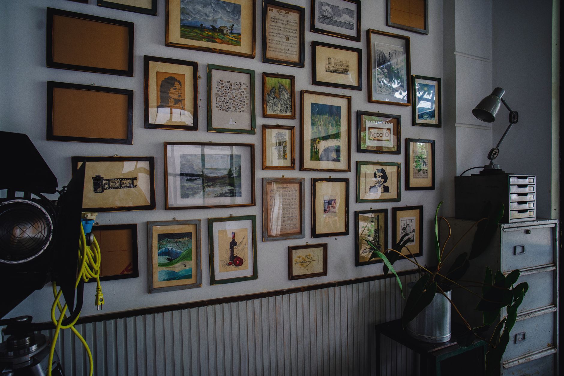 A cozy room with a collection of framed artwork and a modern industrial style.