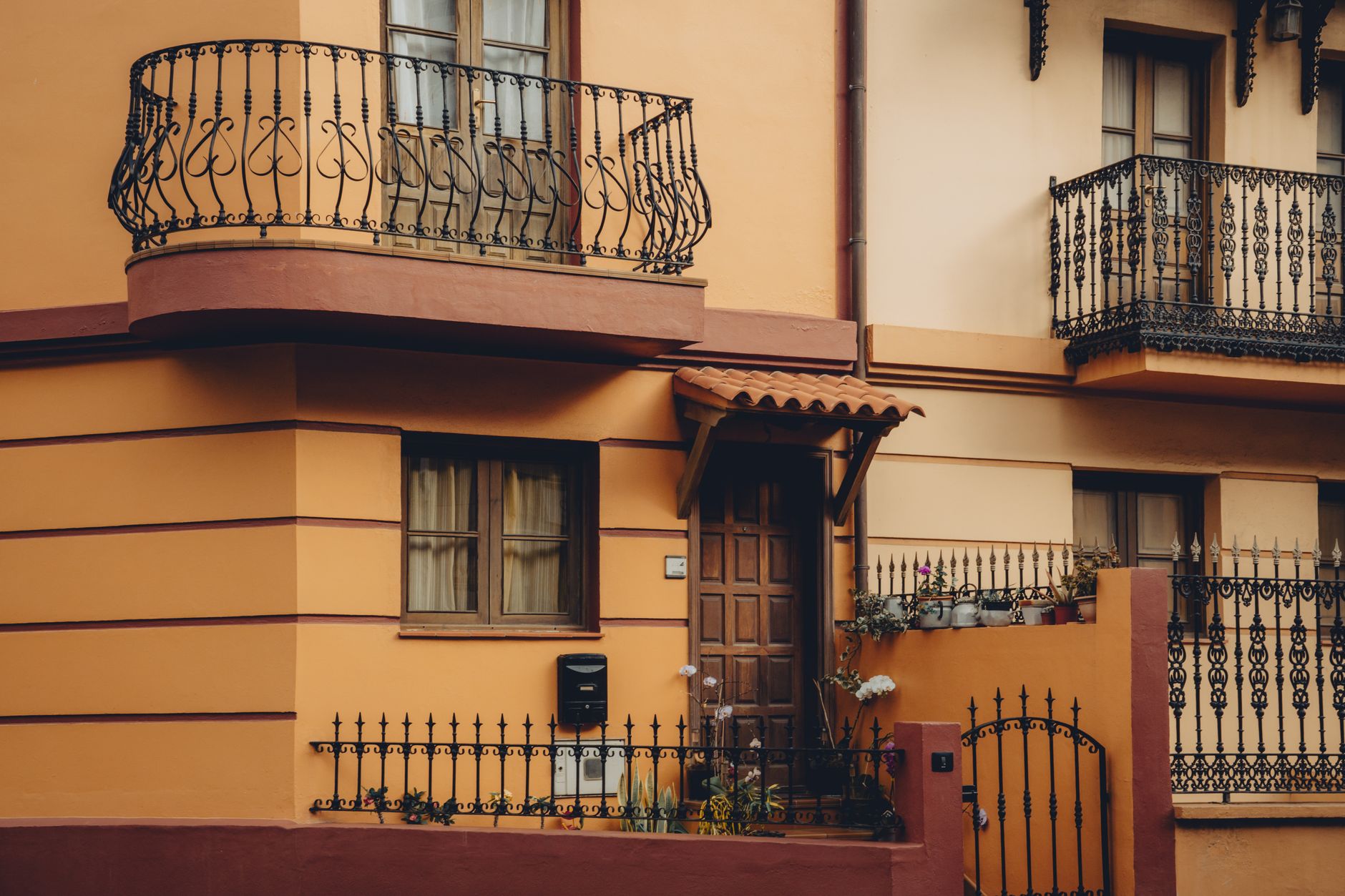 Colorful Mediterranean house facade with wrought iron railings in Vallehermoso, Canary Islands.