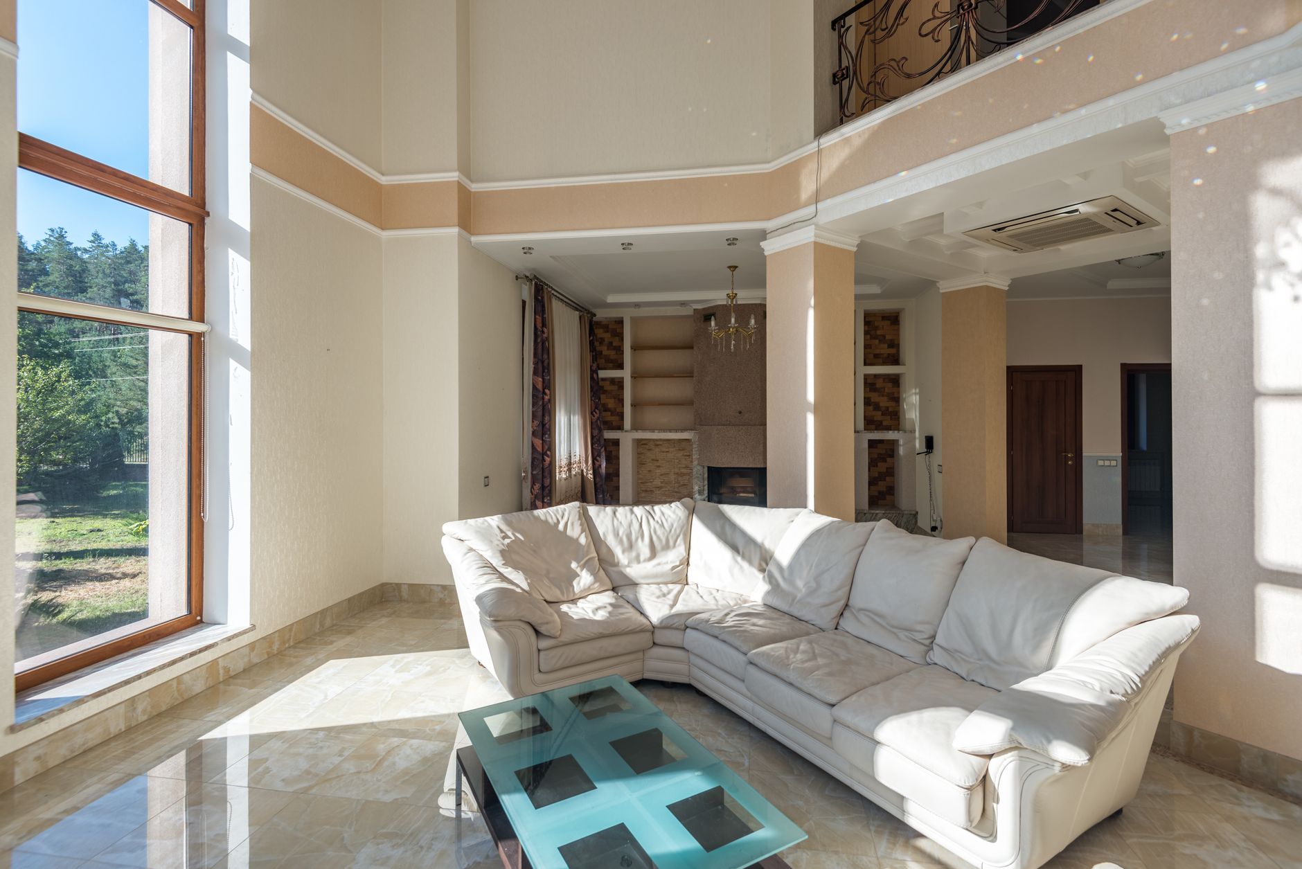 Elegant living room with a large sofa, modern design, and large windows.