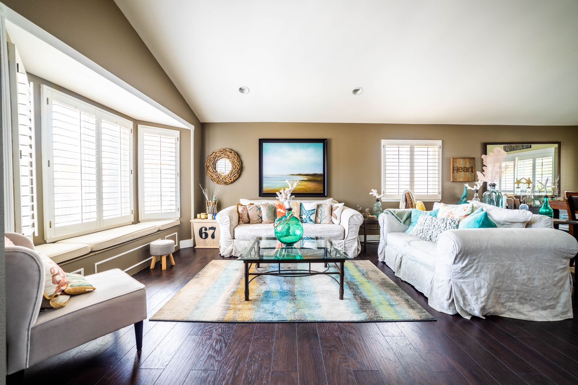 Inviting and stylish living room with white sofas and decorative accents, creating a cozy atmosphere.