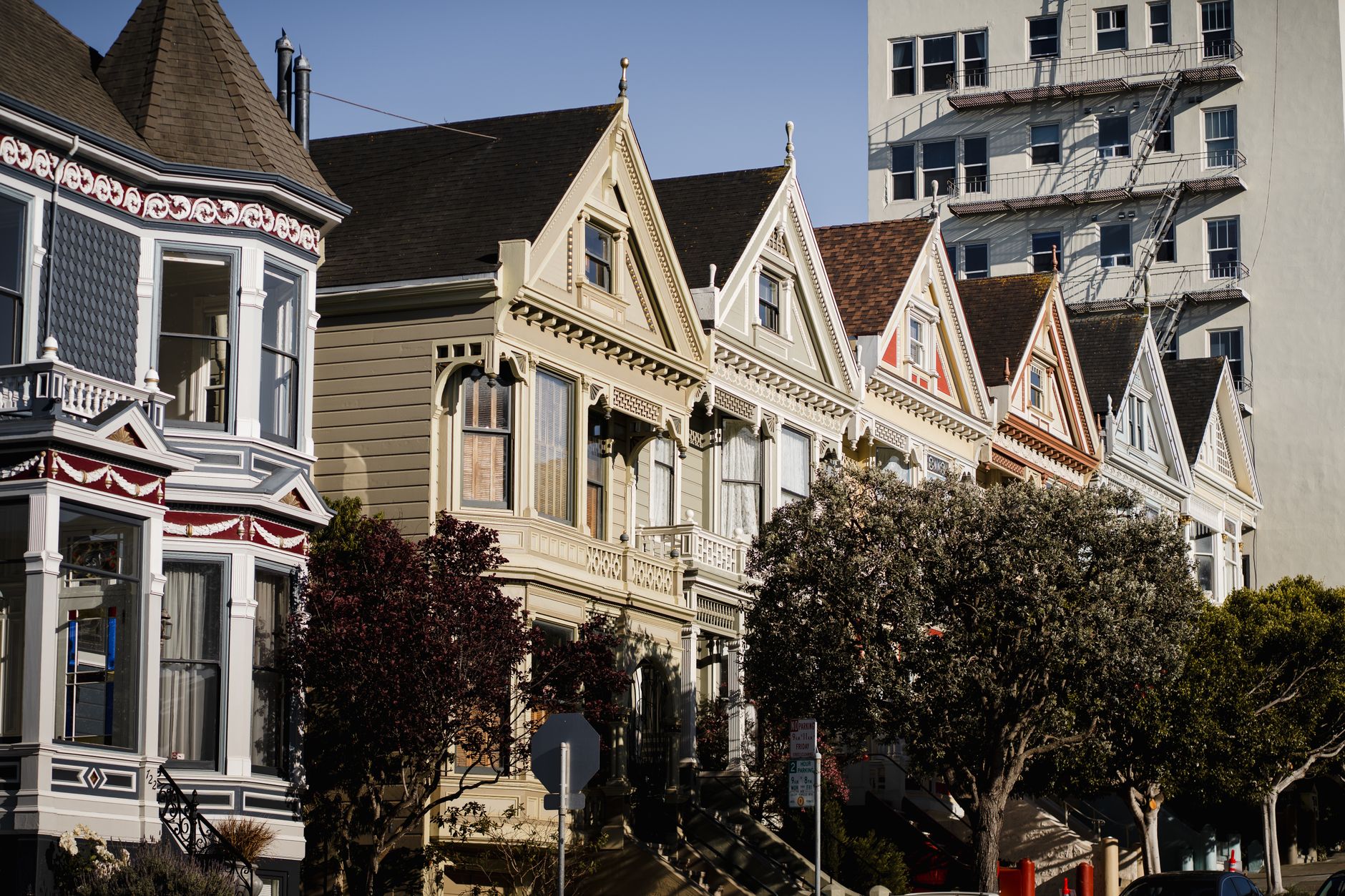 Charming Painted Ladies houses under clear skies in San Francisco, California.