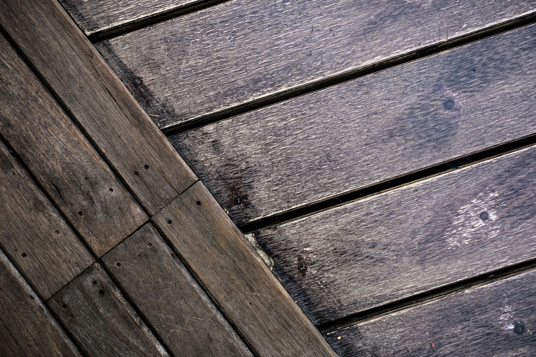 Detailed close-up of a rustic wooden floor showing rich grain patterns and natural wear.