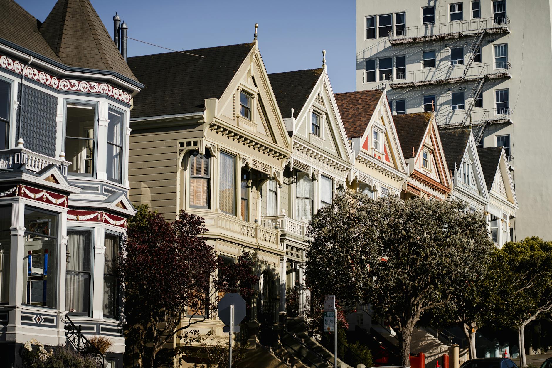 Charming Painted Ladies houses under clear skies in San Francisco, California.