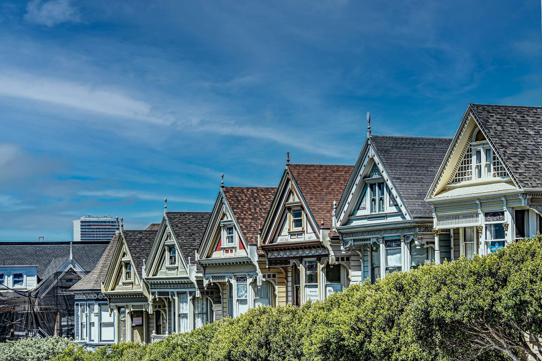 View of the famous Painted Ladies with San Francisco skyline in the background, a classic landmark.