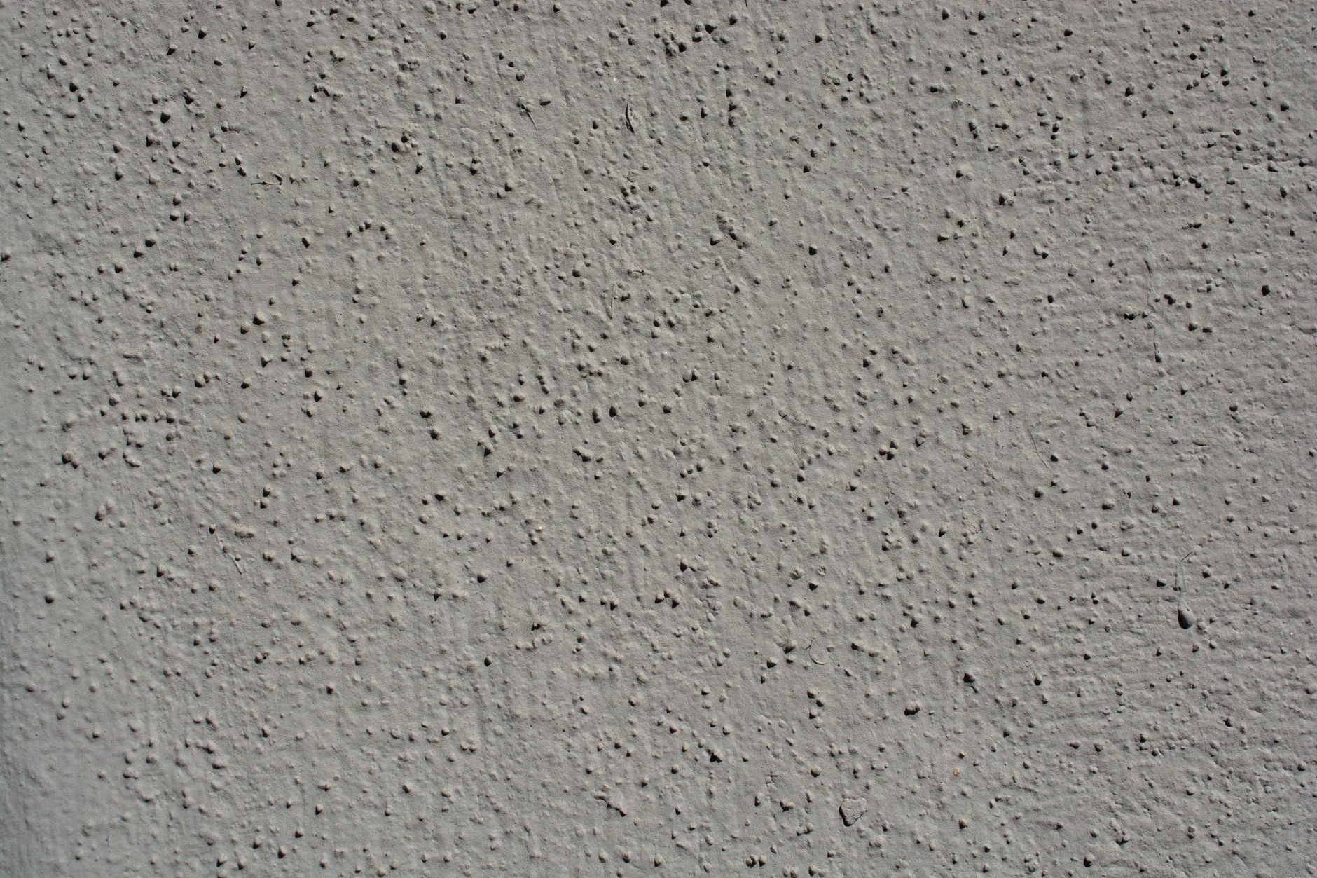 A close-up view showcasing the intricate texture of a gray stucco wall, perfect for backgrounds.