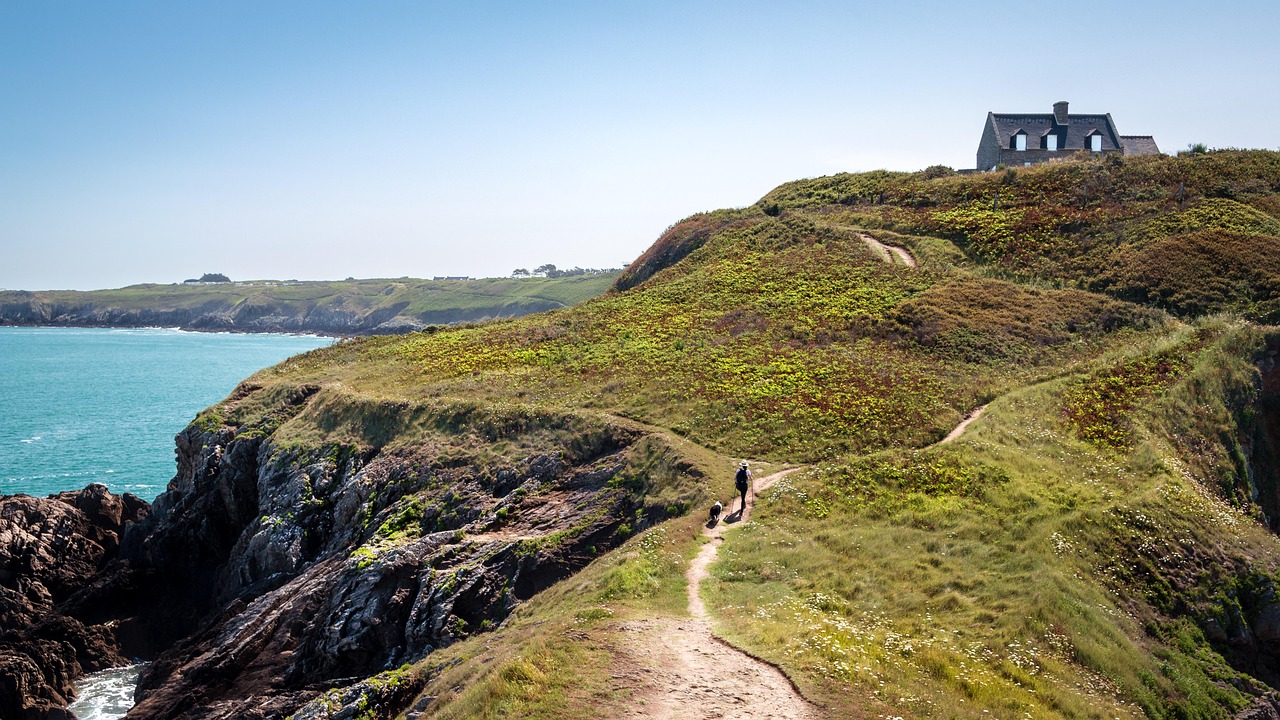 cliffs, house, trail, path, human, pet, dog, walking, trekking, hiking, trek, hike, mountain house, sea, ocean, animal, mountains, landscape, coastline, coast, nature