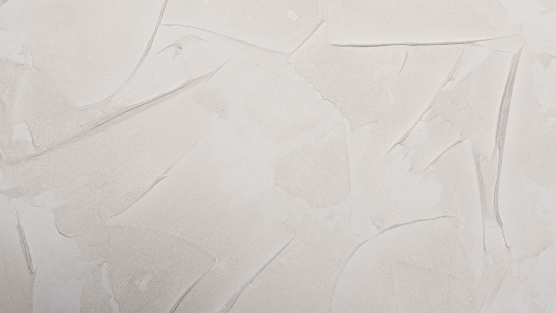 Cream textured abstract wall pattern ideal for backgrounds and design elements.