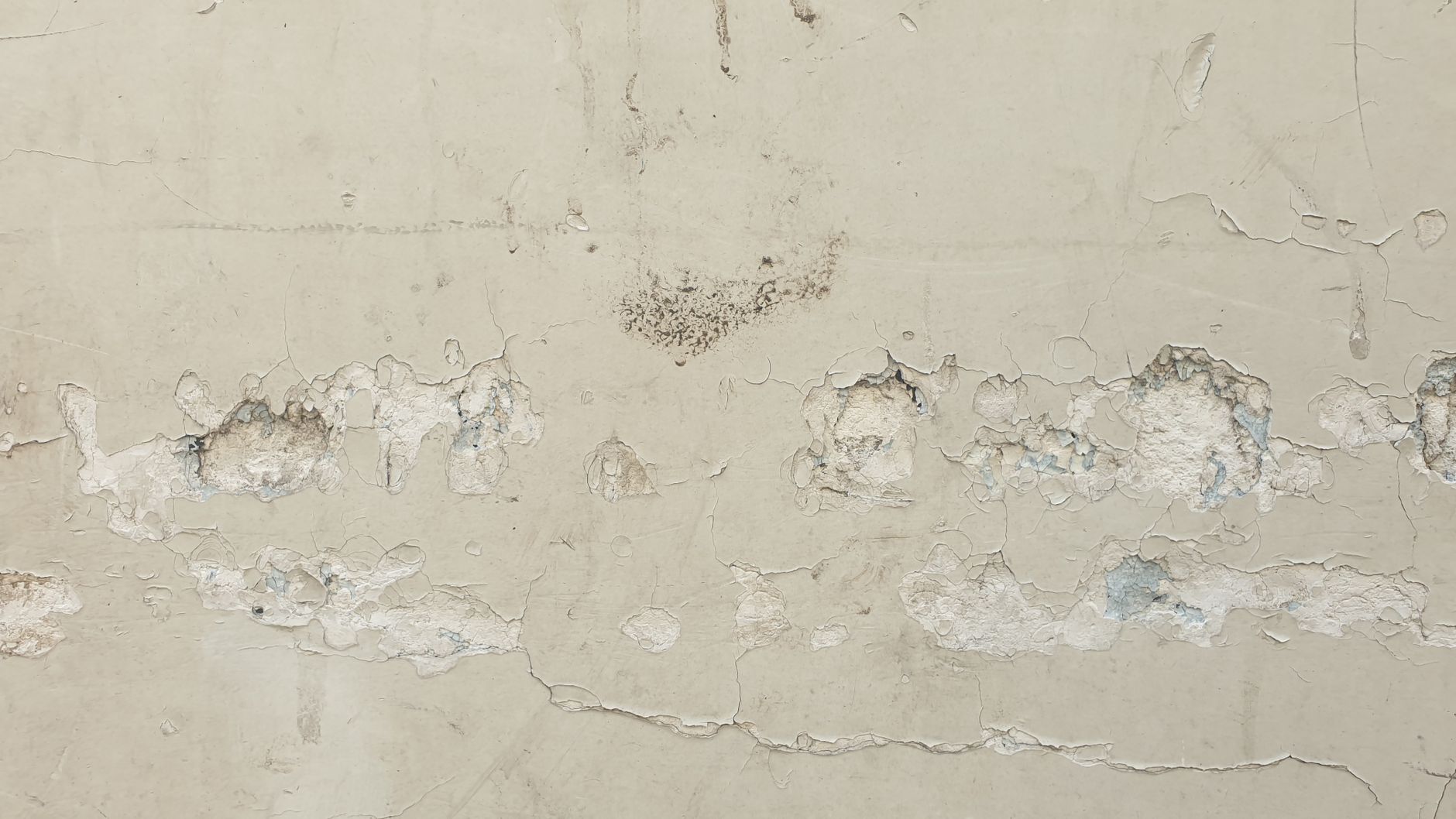 Close-up of an old wall with peeling paint showing unique texture.