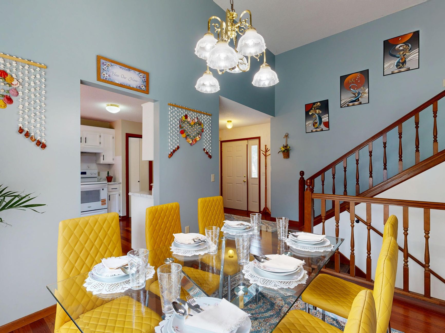 Chic dining room with glass table, yellow chairs, and stylish decor. Perfect for modern interiors.