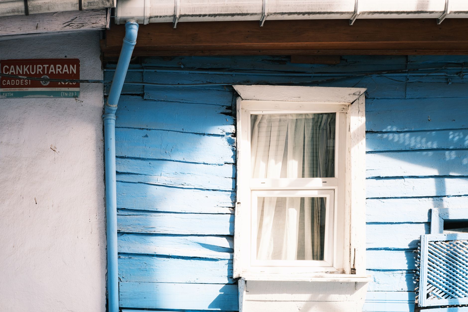 A vintage blue wooden house facade with a window on Cankurtaran Street, Istanbul.