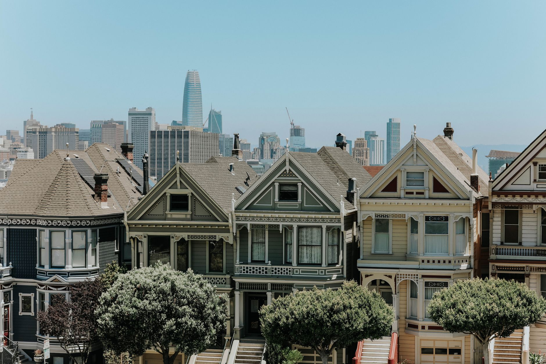 Captivating view of San Francisco's famous Victorian houses with city skyline in the background.