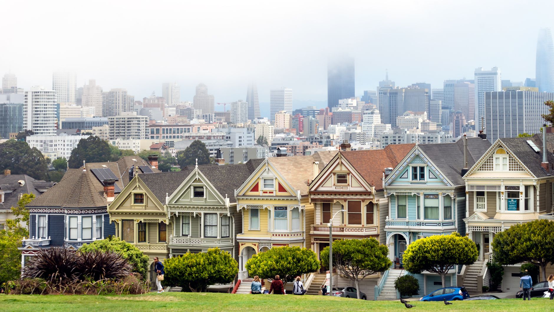 Iconic view of Painted Ladies with San Francisco skyline in the background. A classic urban scene.