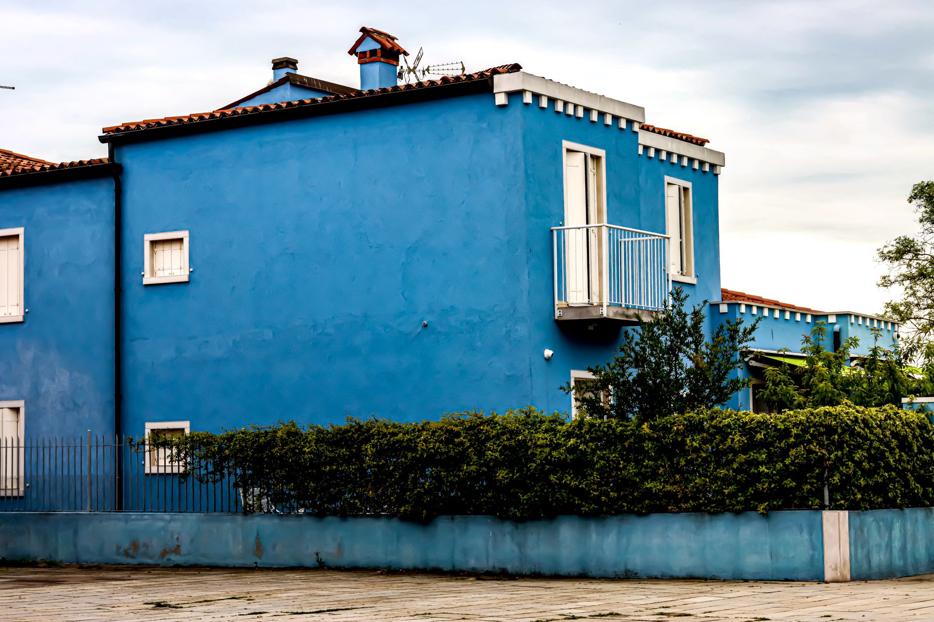 Colorful blue house exterior in Burano, showcasing vibrant architecture in Venice, Italy.