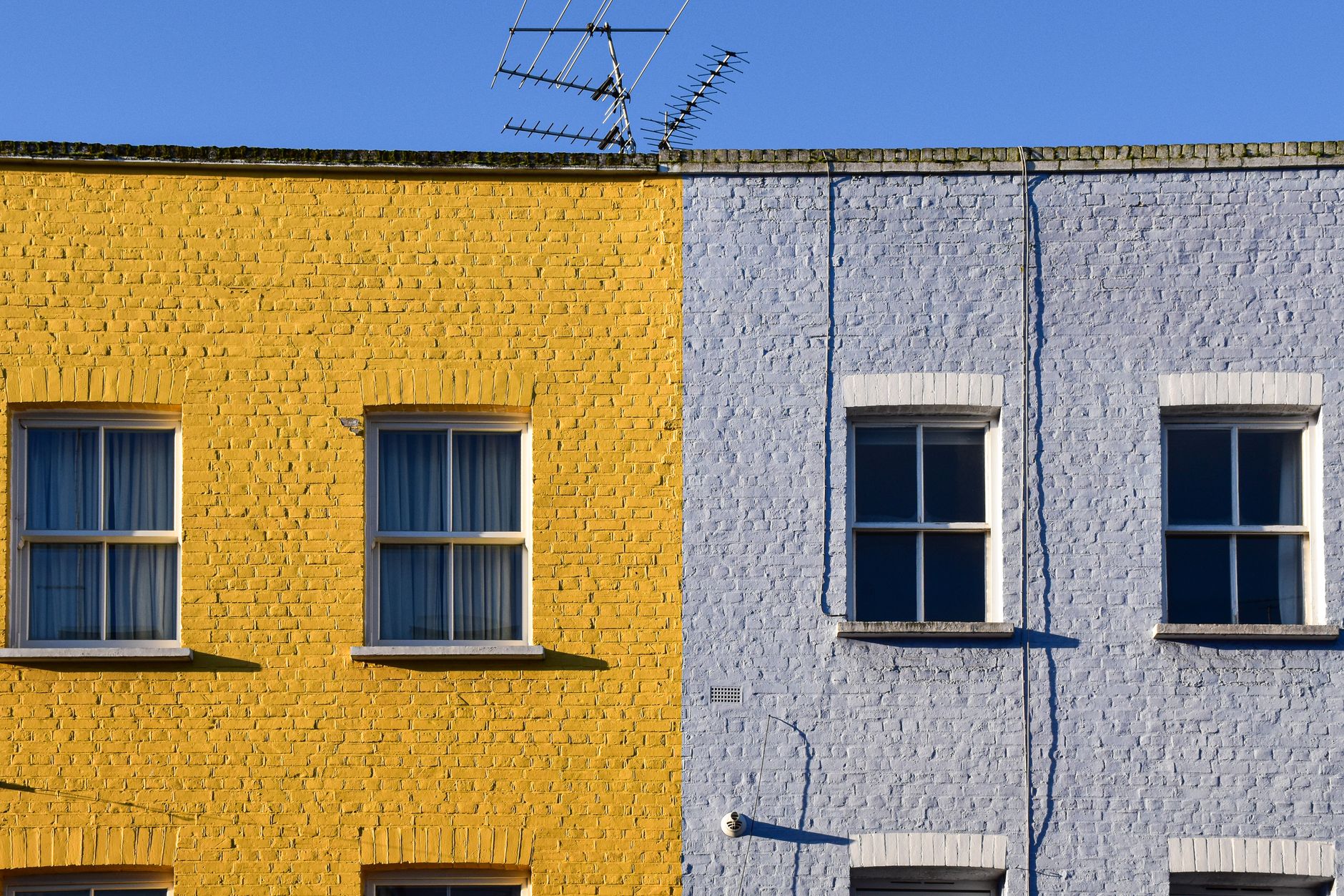 A foggy Berkeley house exterior showing weather-worn paint on wood siding