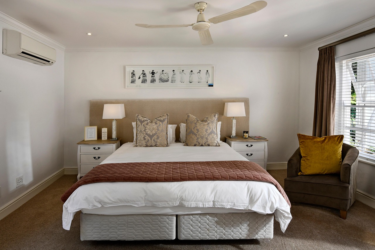 Professional painter applying paint in a Grimmer bedroom with careful edging