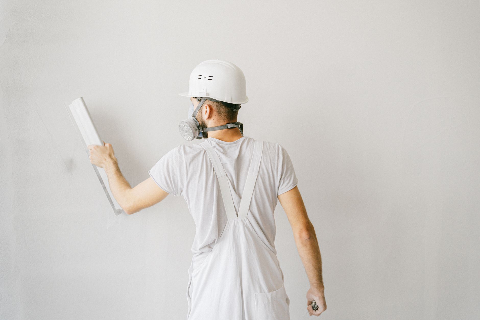 Professional painter applying stucco paint on a Fremont home exterior