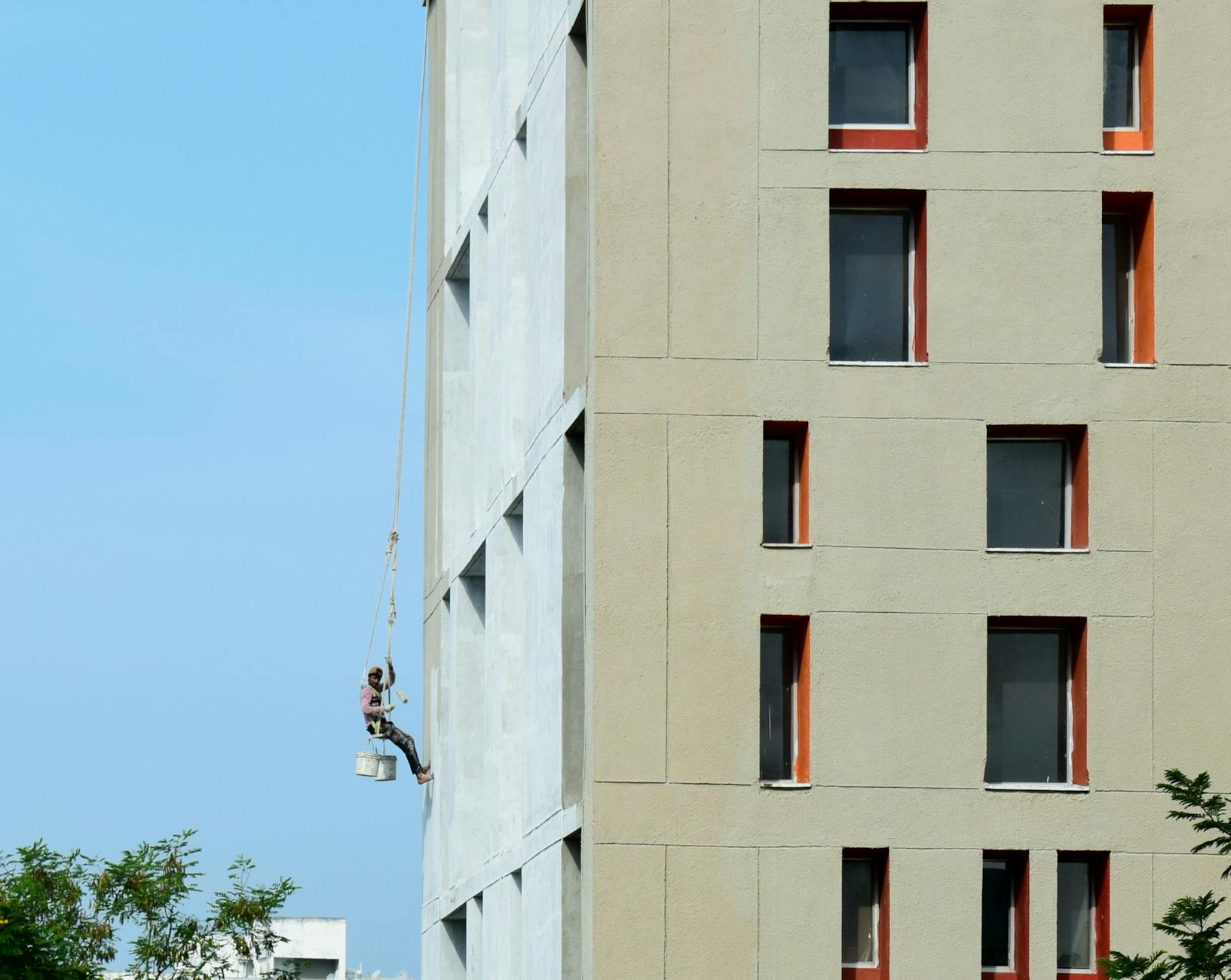 Professional painter applying paint to the exterior of a multi-family building in Glass Bay, Newark, CA