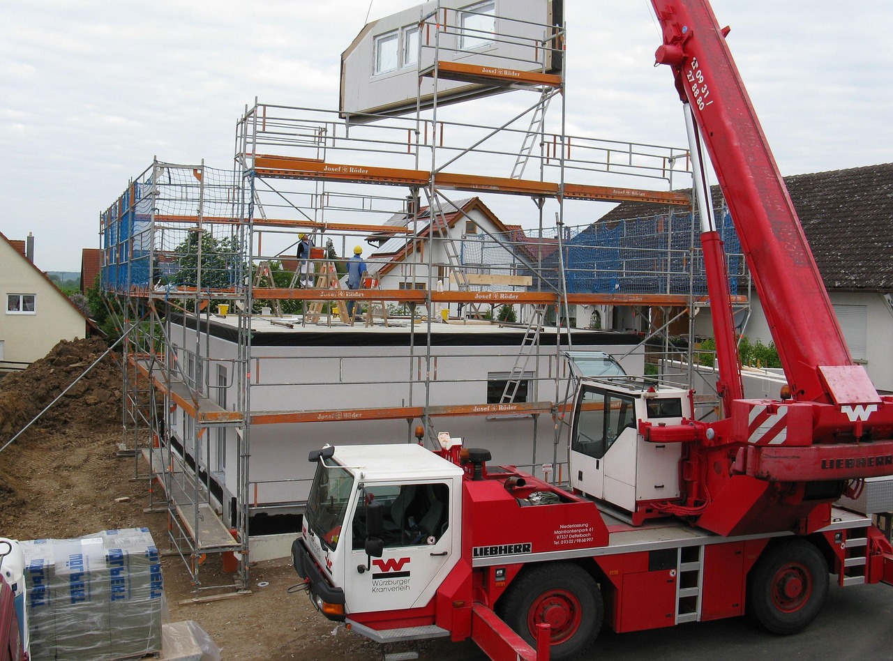 Commercial painter working on scaffolding for an office building exterior