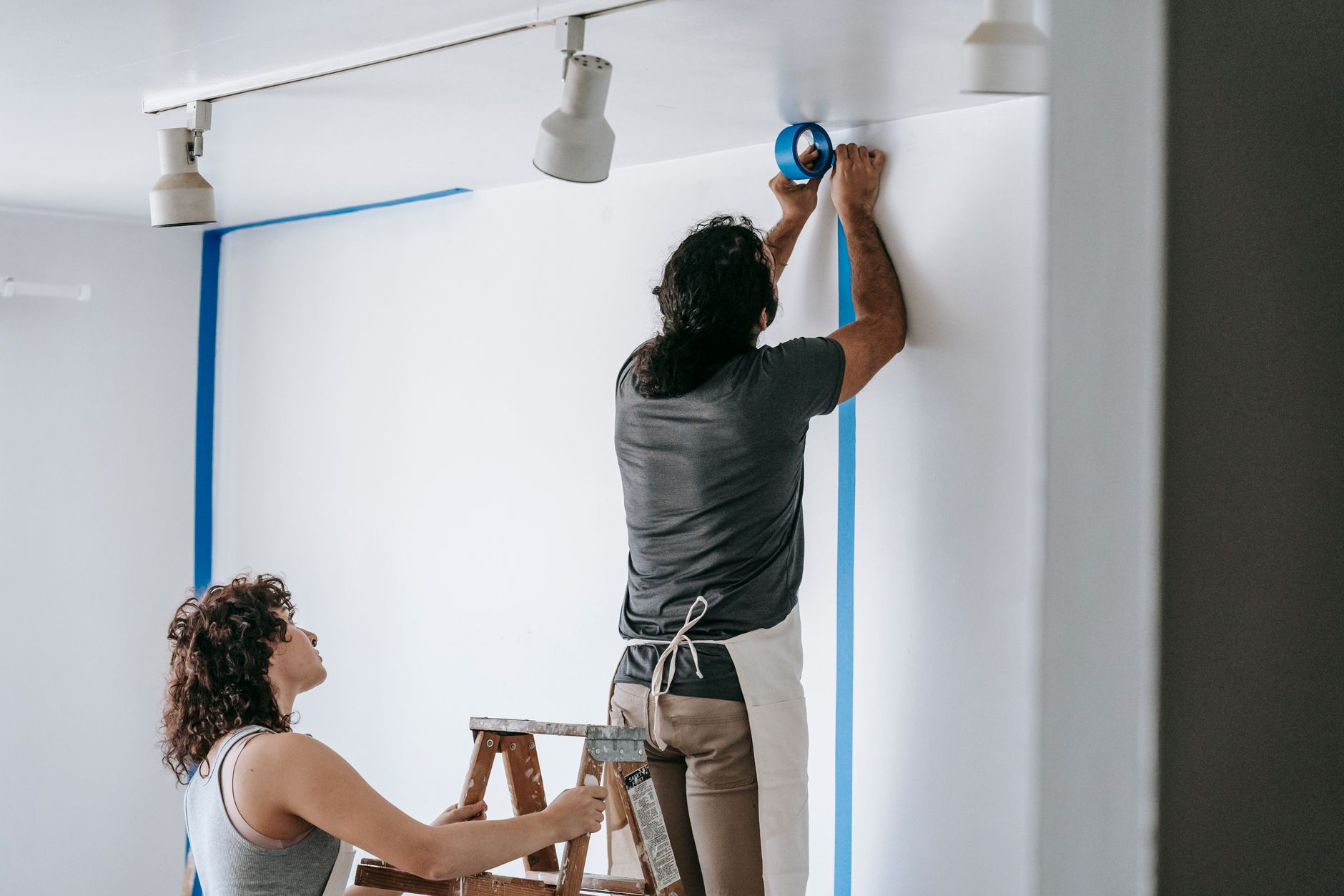 Professional commercial painter inspecting a surface before painting
