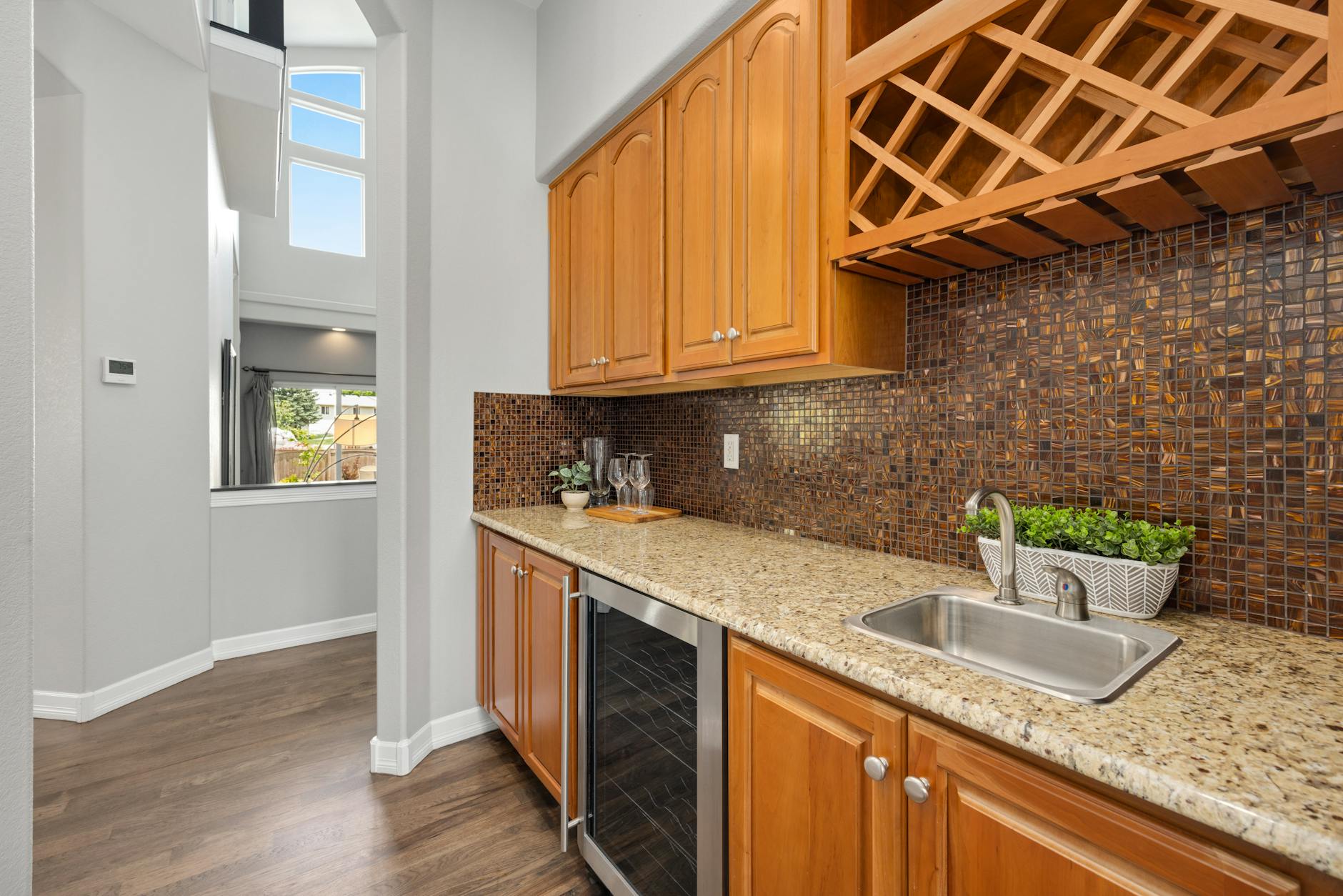 Professional cabinet refinishing in a modern Bay Area kitchen with spray equipment